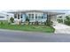 Charming home featuring a well-maintained lawn and an array of potted plants at 2055 S Floral Ave # 42, Bartow, FL 33830