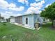 Exterior of a blue home with a screened-in porch and a well-maintained lawn, providing outdoor enjoyment at 2055 S Floral Ave # 42, Bartow, FL 33830