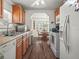 Charming kitchen with wood cabinets, white appliances, and adjacent dining area at 2055 S Floral Ave # 42, Bartow, FL 33830