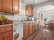This cozy kitchen is equipped with wood cabinets and white appliances at 2055 S Floral Ave # 42, Bartow, FL 33830