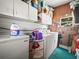 Functional laundry room with washer, dryer, and overhead cabinets for ample storage solutions at 2055 S Floral Ave # 42, Bartow, FL 33830