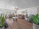 Bright living room featuring wood floors, comfortable seating, and a ceiling fan at 2055 S Floral Ave # 42, Bartow, FL 33830