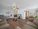 Open living area with wood floors flowing into the dining and kitchen at 2055 S Floral Ave # 42, Bartow, FL 33830