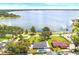 Aerial view of home with pool, surrounded by trees and a scenic lake view at 2096 Lake Ariana Blvd, Auburndale, FL 33823