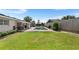 Backyard featuring an in-ground pool, green grass, and modern patio furniture at 2096 Lake Ariana Blvd, Auburndale, FL 33823