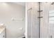 Well-lit bathroom showcasing tiled shower with glass doors and a convenient corner shelf at 2096 Lake Ariana Blvd, Auburndale, FL 33823
