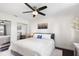 Cozy bedroom with neutral tones, ceiling fan, mirrored closet doors and views to outside at 2096 Lake Ariana Blvd, Auburndale, FL 33823