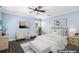 Staged bedroom with white and gray furniture, light blue walls, ceiling fan and dark wood-style flooring at 2096 Lake Ariana Blvd, Auburndale, FL 33823