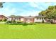 Charming single-story home with shutters, well-manicured lawn and mature landscaping in front yard at 2096 Lake Ariana Blvd, Auburndale, FL 33823