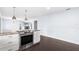 Open-concept kitchen with stainless steel oven, white cabinets, and stone countertops at 2096 Lake Ariana Blvd, Auburndale, FL 33823