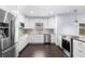 Modern kitchen features stainless steel appliances, including a double door refrigerator, and white cabinets at 2096 Lake Ariana Blvd, Auburndale, FL 33823