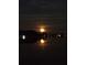 A full moon glows over a tranquil lake, casting a shimmering reflection on the water at 2096 Lake Ariana Blvd, Auburndale, FL 33823