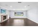 Spacious living room featuring dark wood floors, fireplace with TV, and window providing ample natural light at 2096 Lake Ariana Blvd, Auburndale, FL 33823