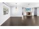 Spacious living room with a fireplace, a TV, and natural light, and an adjacent room providing more living space at 2096 Lake Ariana Blvd, Auburndale, FL 33823