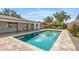 A stunning, modern pool with stone surround and meticulous landscaping at 2096 Lake Ariana Blvd, Auburndale, FL 33823