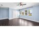Room with light blue walls, multiple view windows, ceiling fan, closet doors and dark wood-style flooring at 2096 Lake Ariana Blvd, Auburndale, FL 33823