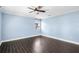 Room with light blue walls, single view window, and dark wood-style flooring at 2096 Lake Ariana Blvd, Auburndale, FL 33823