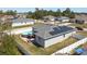 Aerial view of a fenced-in home with solar panels, above ground pool, and back patio at 229 Elm Ct, Kissimmee, FL 34759