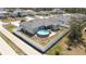 Aerial view of a home with a fenced yard, above ground pool, and back patio at 229 Elm Ct, Kissimmee, FL 34759
