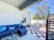 Cozy backyard patio with outdoor seating, dining area, and a deck with stairs at 229 Elm Ct, Kissimmee, FL 34759