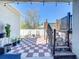 Cozy backyard patio featuring a checkered tile floor, dining area, and deck with stairs at 229 Elm Ct, Kissimmee, FL 34759