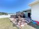 Backyard patio featuring a checkered tile floor, dining area, and deck with stairs at 229 Elm Ct, Kissimmee, FL 34759