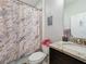 Bathroom featuring a shower with a decorative marble curtain at 229 Elm Ct, Kissimmee, FL 34759
