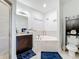 Bright bathroom featuring a soaking tub, vanity, and toilet with dark wood cabinets at 229 Elm Ct, Kissimmee, FL 34759