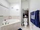 Bright bathroom featuring a soaking tub, toilet, and towel rack with light walls at 229 Elm Ct, Kissimmee, FL 34759