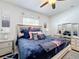 Beautiful bedroom featuring an upholstered bed and mirrored furniture at 229 Elm Ct, Kissimmee, FL 34759