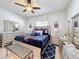 Elegantly decorated bedroom with mirrored furniture and modern ceiling fan at 229 Elm Ct, Kissimmee, FL 34759