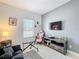 Bright bedroom with tiled floors, a sofa, and a gaming setup, creating a versatile recreational space at 229 Elm Ct, Kissimmee, FL 34759