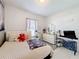 Bright bedroom features neutral walls, a window for natural light, and comfortable furnishings at 229 Elm Ct, Kissimmee, FL 34759