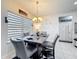 Dining room featuring a modern chandelier and a table set for four, perfect for intimate meals at 229 Elm Ct, Kissimmee, FL 34759