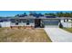 Charming single-story home with solar panels and well-manicured lawn at 229 Elm Ct, Kissimmee, FL 34759