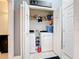 Well-lit laundry room with washer, dryer, and shelving at 229 Elm Ct, Kissimmee, FL 34759
