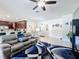 Open-concept living space with modern fixtures, kitchen bar, and tile flooring at 229 Elm Ct, Kissimmee, FL 34759