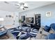 Modern living room with ceiling fan, tile floors, and a sleek entertainment center for a contemporary feel at 229 Elm Ct, Kissimmee, FL 34759
