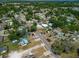 The house is situated in a residential area surrounded by trees, streets, and neighboring houses at 2301 Freemason St, Lakeland, FL 33801