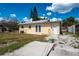 The exterior rear of the house features a door and a modest outdoor space for entertainment at 2301 Freemason St, Lakeland, FL 33801