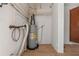 Utility area with water heater, plumbing and some storage space at 2301 Freemason St, Lakeland, FL 33801