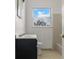 Bathroom featuring a vanity, toilet, tile and a window at 2301 Freemason St, Lakeland, FL 33801