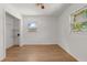 Bright bedroom with wood floors, white walls, closet, and windows for natural light at 2301 Freemason St, Lakeland, FL 33801