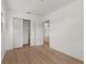 Bright bedroom with wood floors, white walls, a closet and view to another room at 2301 Freemason St, Lakeland, FL 33801