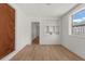 Bedroom featuring natural light, wood-look floors, and a built-in bookshelf at 2301 Freemason St, Lakeland, FL 33801