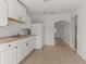 Bright, white kitchen featuring wood counters and stainless steel appliances, with an opening leading to the rest of the home at 2301 Freemason St, Lakeland, FL 33801