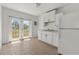 Bright kitchen featuring white cabinets, a stainless steel sink, and double doors with an exterior view at 2301 Freemason St, Lakeland, FL 33801
