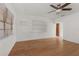 Bright living room featuring hardwood floors, neutral walls, and a modern ceiling fan at 2301 Freemason St, Lakeland, FL 33801