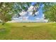Backyard showing grass, trees, and a grate at 2654 Rutledge Ct, Winter Haven, FL 33884