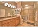 Bathroom with double sinks, tile floors, and a walk-in shower with glass door at 2654 Rutledge Ct, Winter Haven, FL 33884